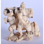 A 19TH CENTURY JAPANESE MEIJI PERIOD CARVED IVORY OKIMONO modelled as three oni beside a male warrio