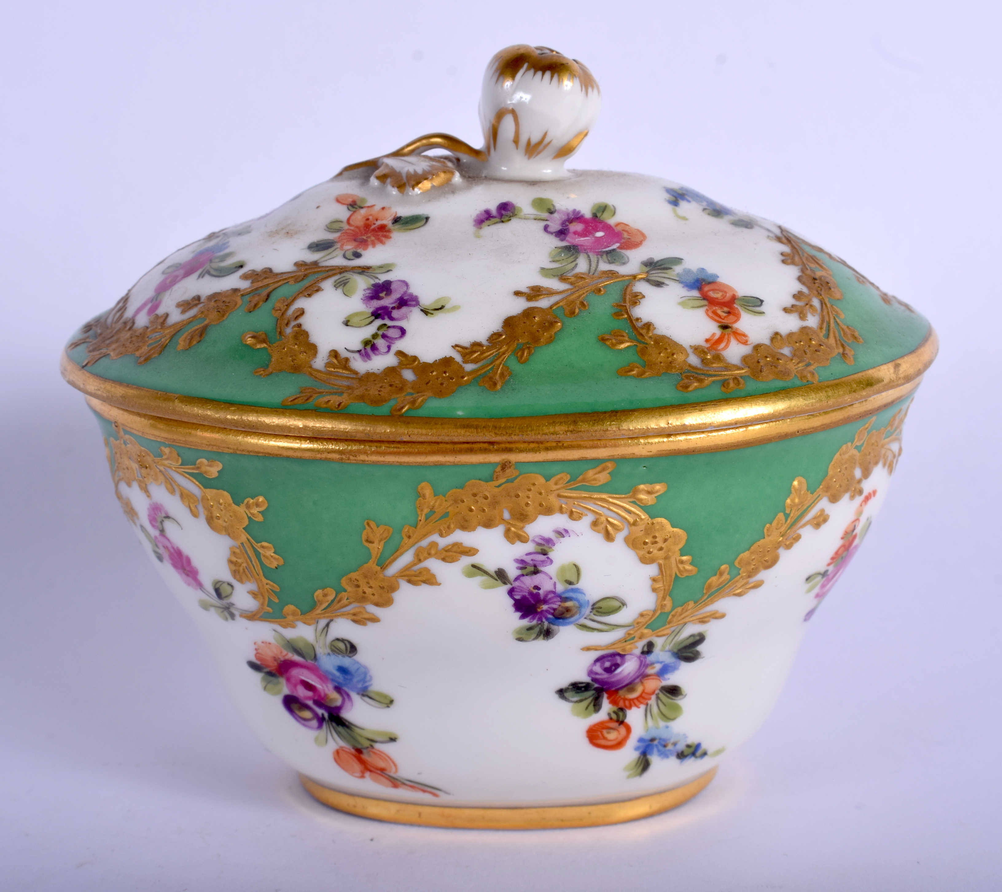 19th c. Paris porcelain oval box and cover painted with flowers in a shape raised gilt panel on an a