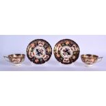 Royal Crown Derby pair of pedestal teacups and saucers painted with imari pattern 9022.