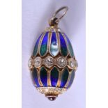 A SILVER ENAMEL AND RUBY EGG PENDANT. 2.75 cm x 1.5 cm.