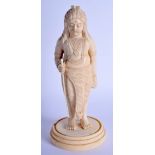 A 19TH CENTURY ANGLO INDIAN CARVED IVORY FIGURE OF A STANDING MALE modelled holding a staff upon a c