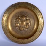A LARGE 16TH/17TH CENTURY NUREMBERG BRASS ALMS DISH decorated with motifs and fruiting pods. 38 cm d