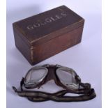 A CHARMING VINTAGE PAIR OF GOGGLES in a period carved wood box. 20 cm wide. (2)