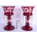 A PAIR OF ANTIQUE CRANBERRY GLASS LUSTRES decorated with hunting scenes. 31 cm high.