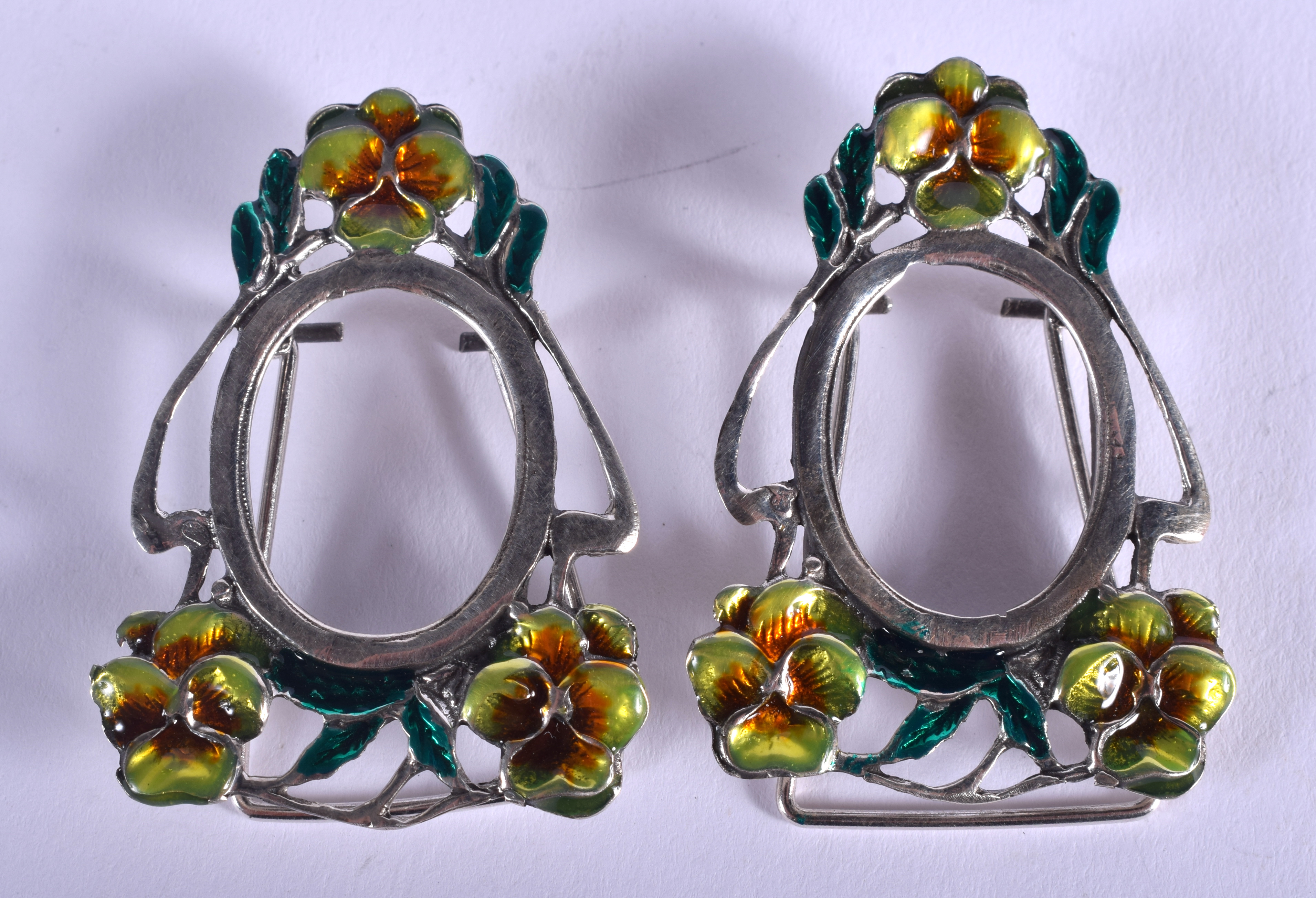 A PAIR OF CONTINENTAL SILVER AND ENAMEL FRAMES. 13 grams. 4 cm x 3 cm.