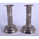 A PAIR OF ANTIQUE OPENWORK SILVER CANDLESTICKS. London. 499 grams possibly weighted. 15 cm high.