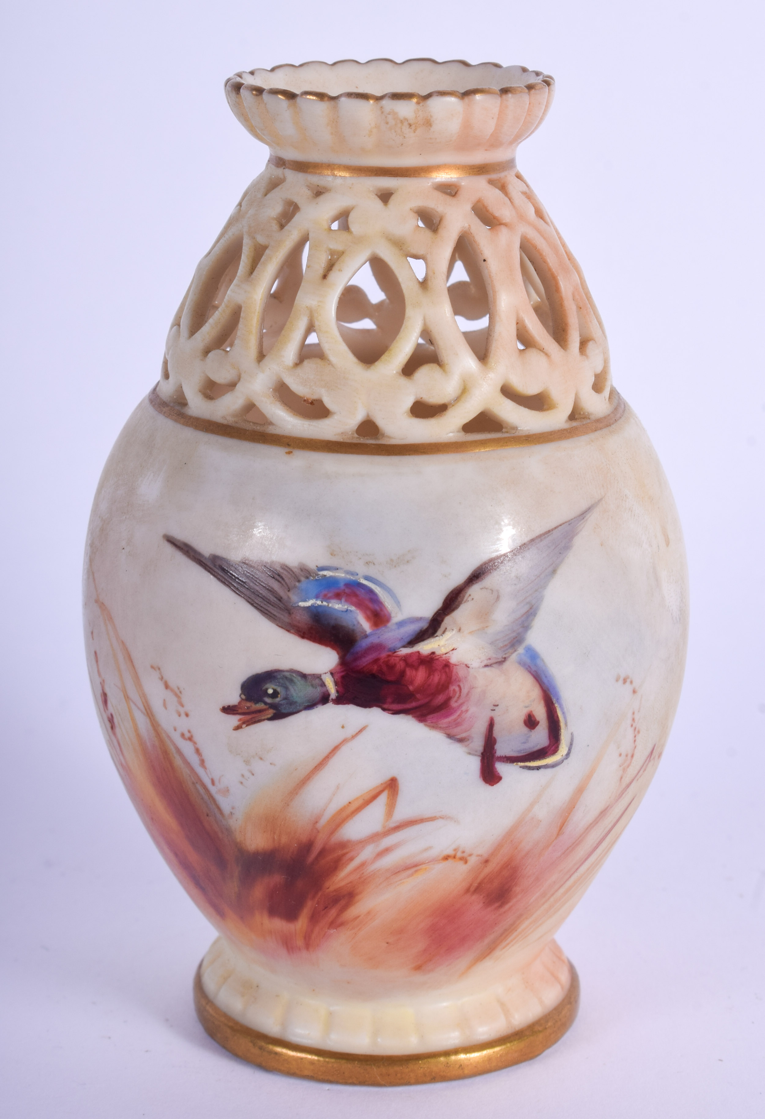 A ROYAL WORCESTER OPENWORK PORCELAIN VASE painted with birds. 11 cm high.