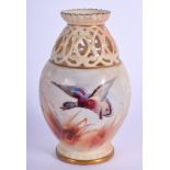 A ROYAL WORCESTER OPENWORK PORCELAIN VASE painted with birds. 11 cm high.