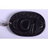 A NATIVE AMERICAN ARGILLITE PENDANT signed Denny Dixon Skidegate 5/77. 4 cm x 5.5 cm.