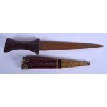 A 19TH CENTURY MIDDLE EASTERN CARVED RHINOCEROS HORN HANDLED DAGGER with leather scabbard. 25 cm lon