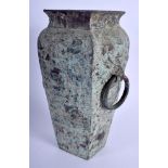 A 1930S CHINESE BRONZE SQUARE FORM VASE of archaic form, decorated with mask heads. 23 cm x 9 cm.