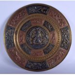 A LARGE EARLY 20TH CENTURY INDIAN SILVER AND COPPER BRASS CHARGER decorated with a portrait of Ganes