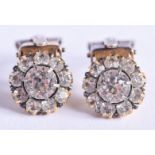 A PAIR OF ANTIQUE 9CT GOLD AND DIAMOND DAISY CLUSTER EARRINGS of approx 0.75 cts. 2.3 grams. 1 cm wi