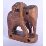 AN EARLY 20TH CENTURY INDIAN CARVED WOOD FIGURE OF AN ELEPHANT Possibly Rajasthan. 15 cm x 11 cm.