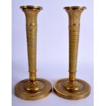 A PAIR OF 19TH CENTURY FRENCH BRASS CANDLESTICKS decorated with foliage and vines. 24.5 cm high.