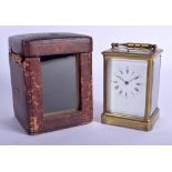 A 19TH CENTURY FRENCH BRASS REPEATING CARRIAGE CLOCK within original fitted leather case. 18 cm high