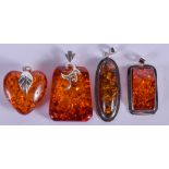 FOUR SILVER AND AMBER PENDANTS. (4)