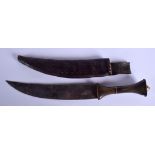 A 19TH CENTURY MIDDLE EASTERN CARVED RHINOCEROS HORN HANDLED KNIFE with leather scabbard. 32 cm long