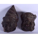 A PAIR OF 19TH CENTURY NORTH EUROPEAN CARVED WOOD HEADS. 16 cm x 6 cm.