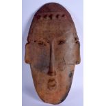 A LARGE SOUTH AMERICAN PRE COLUMBIAN POTTERY MASK HEAD of elongated form. 42 cm x 21 cm.