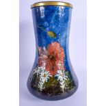 AN ANTIQUE FRENCH ENAMELLED POTTERY VASE painted with foliage upon a blue ground, signed EG. 27 cm x