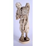 A 19TH CENTURY JAPANESE MEIJI PERIOD CARVED IVORY OKIMONO modelled as a male holding a lantern. 20 c