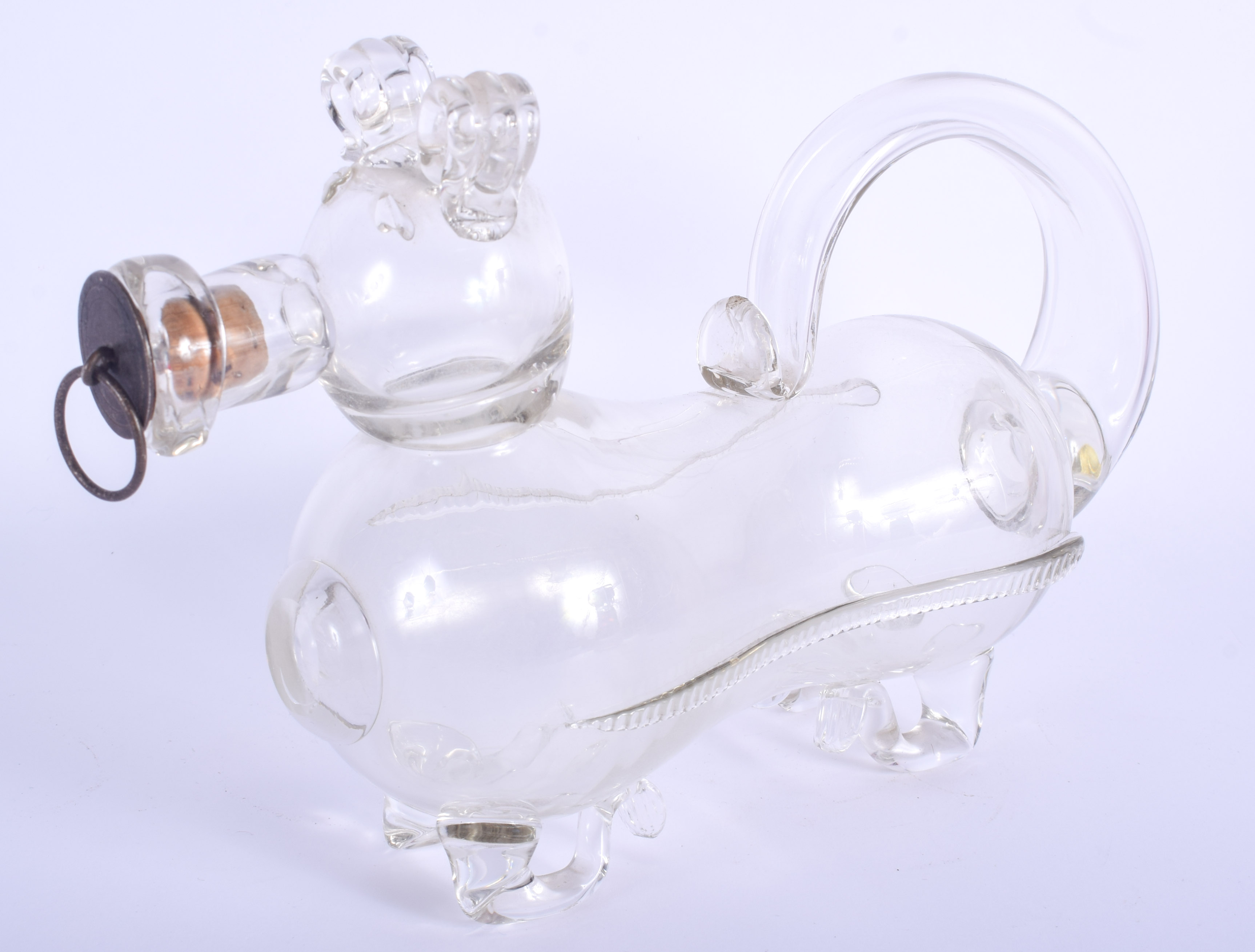 AN ANTIQUE NOVELTY GLASS DECANTER in the form of a recumbent dog. 27 cm x 18 cm.