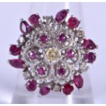 A 14CT GOLD RUBY AND DIAMOND CLUSTER RING. 6.9 grams. P.