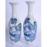 A PAIR OF CHINESE BLUE AND WHITE PORCELAIN VASES 20th Century, decorated with dragons amongst clouds