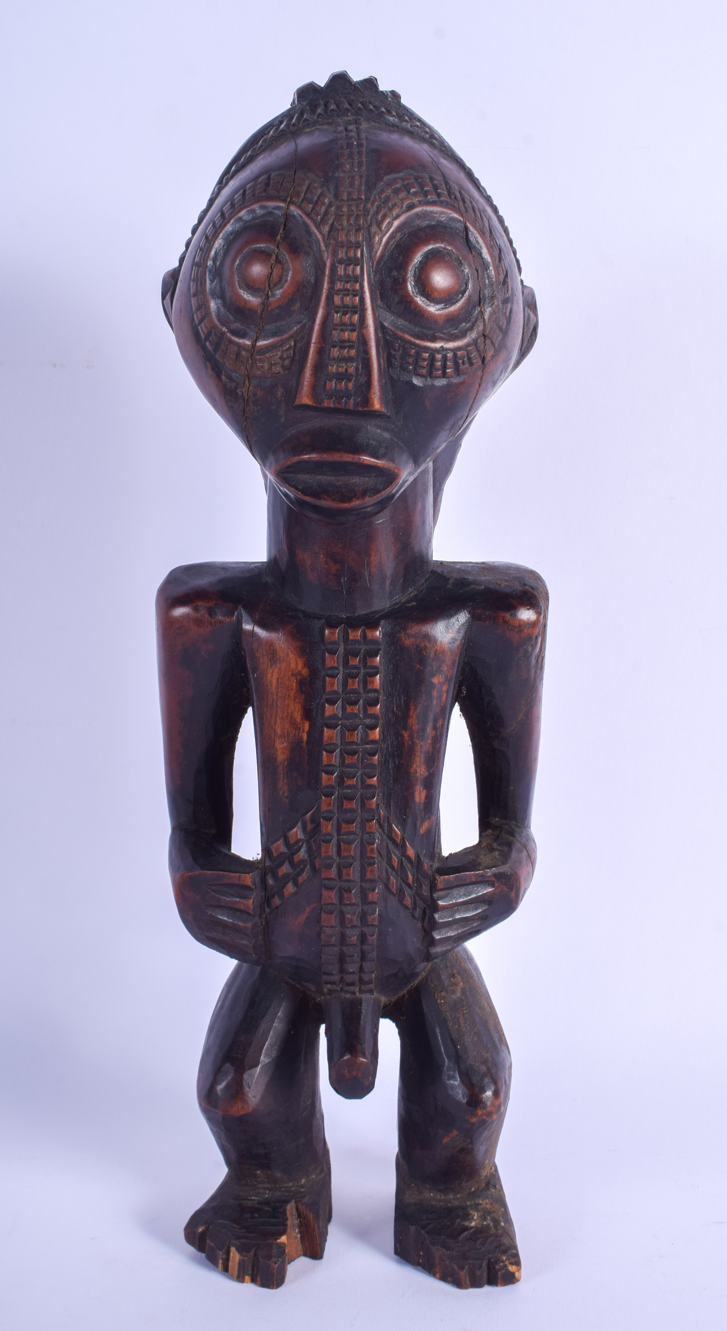 AN UNUSUAL AFRICAN TRIBAL CARVED WOOD LUBA FIGURE modelled with braided hair. 33 cm high.
