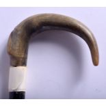 A 19TH CENTURY CONTINENTAL CARVED RHINOCEROS HORN HANDLED WALKING STICK. 85 cm long.