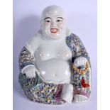 A CHINESE FAMILLE ROSE PORCELAIN BUDDHA 20th Century, decorated with foliage. 28 cm x 17 cm.