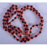 AN ART DECO CORAL AND JET NECKLACE. Each strand 40 cm long.
