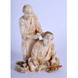 A 19TH CENTURY JAPANESE MEIJI PERIOD CARVED IVORY OKIMONO modelled as a male picking wax from anothe