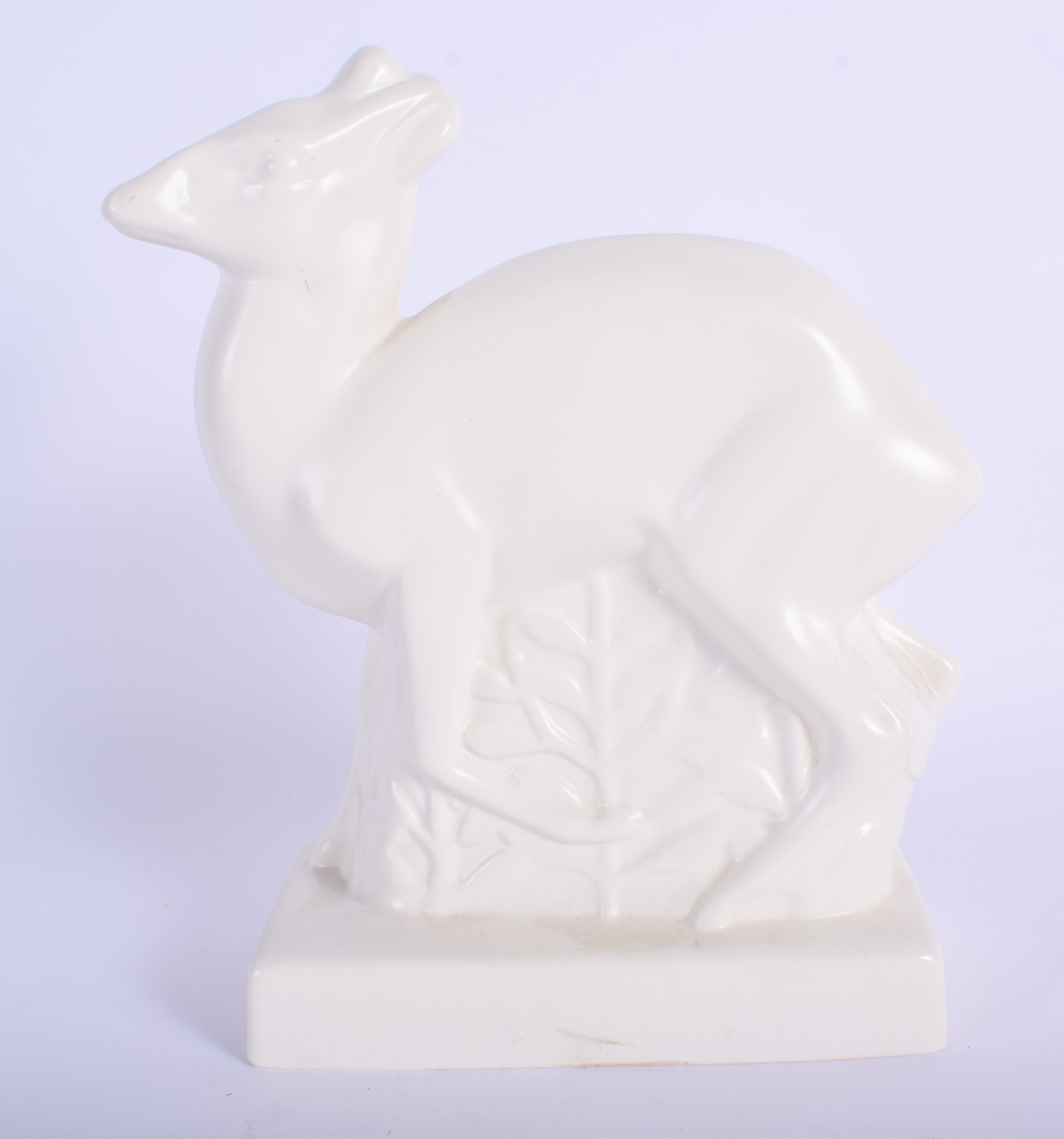 A 1930S WEDGWOOD WHITE GLAZED POTTERY FIGURE OF A DEER designed by John Skeaping. 16 cm x 21 cm.