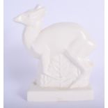 A 1930S WEDGWOOD WHITE GLAZED POTTERY FIGURE OF A DEER designed by John Skeaping. 16 cm x 21 cm.