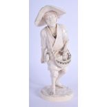 A 19TH CENTURY JAPANESE MEIJI PERIOD CARVED IVORY OKIMONO modelled as a roaming male holding a baske