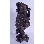 A 19TH CENTURY CHINESE CARVED ROOT WOOD FIGURE OF AN IMMORTAL modelled upon a rocky outcrop. 39 cm h