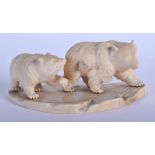 A 19TH CENTURY JAPANESE MEIJI PERIOD CARVED IVORY OKIMONO modelled with two roaming bears. 13 cm x 6