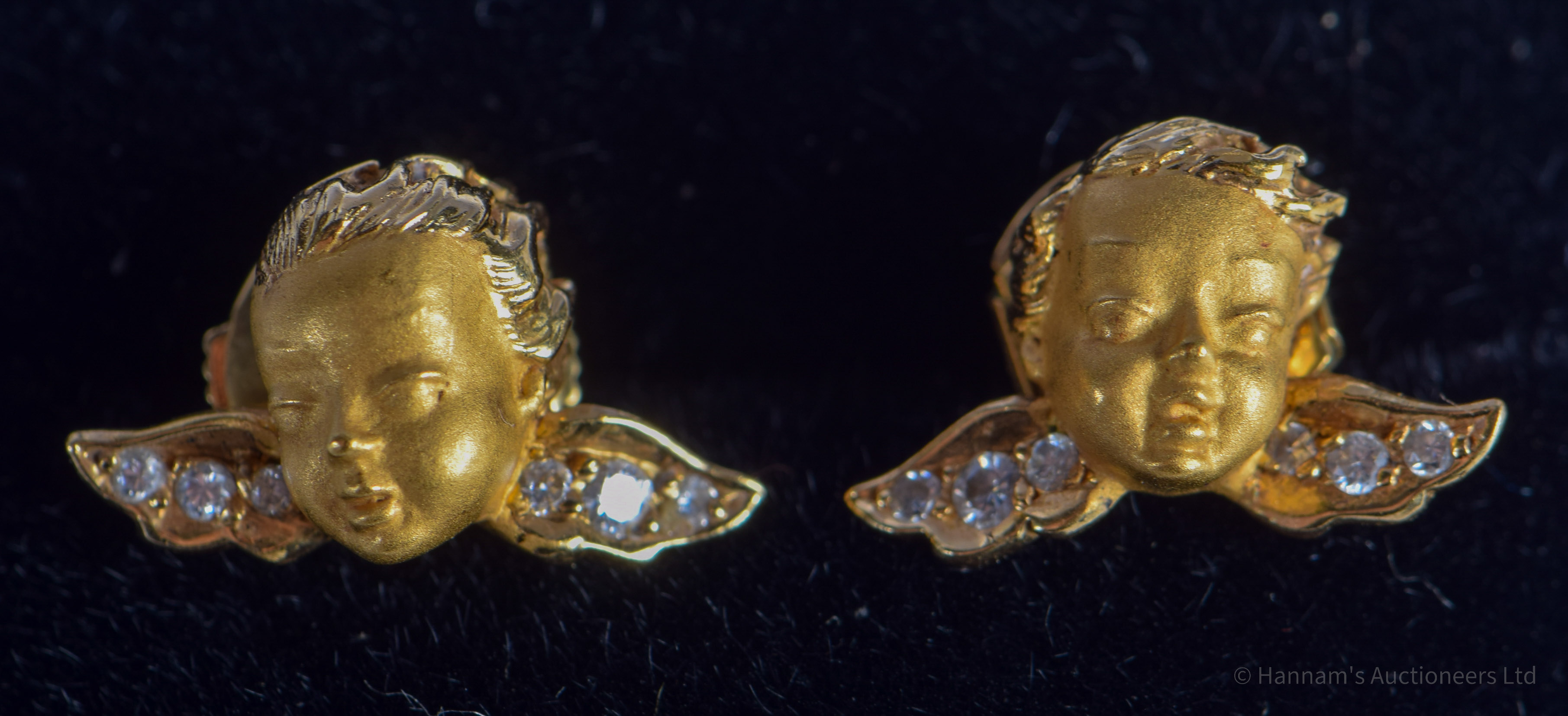 A PAIR OF 18CT GOLD AND DIAMOND CUPID EARRINGS. 3.8 grams. 1.4 cm x 0.8 cm.