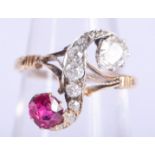 AN UNUSUAL GOLD DIAMOND AND RUBY TWIST RING. 3.2 grams. M/N.