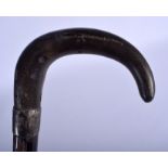 A 19TH CENTURY CARVED RHINOCEROS HORN HANDLED WALKING CANE. 90 cm long.