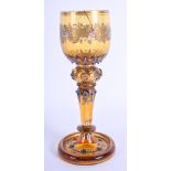 A LOVELY ANTIQUE CONTINENTAL AMBER GLASS probably German, overlaid in enamel and jewelled. 17 cm hig