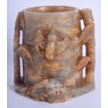 A CHINESE CARVED MUTTON JADE BRUSH POT 20th Century, overlaid with bats and bamboo supports. 10 cm x