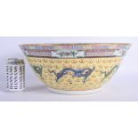 A LARGE EARLY 20TH CENTURY CHINESE FAMILLE JAUNE BOWL Qing/Republic, painted with dragons amongst cl