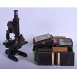A VINTAGE SCIENTIFIC BAUSCH & LOMB MICROSCOPE together with assorted slides. Microscope 32 cm high.