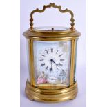AN EARLY 20TH CENTURY FRENCH BRASS OVAL REPEATING CARRIAGE CLOCK inset with an enamel panel of roma