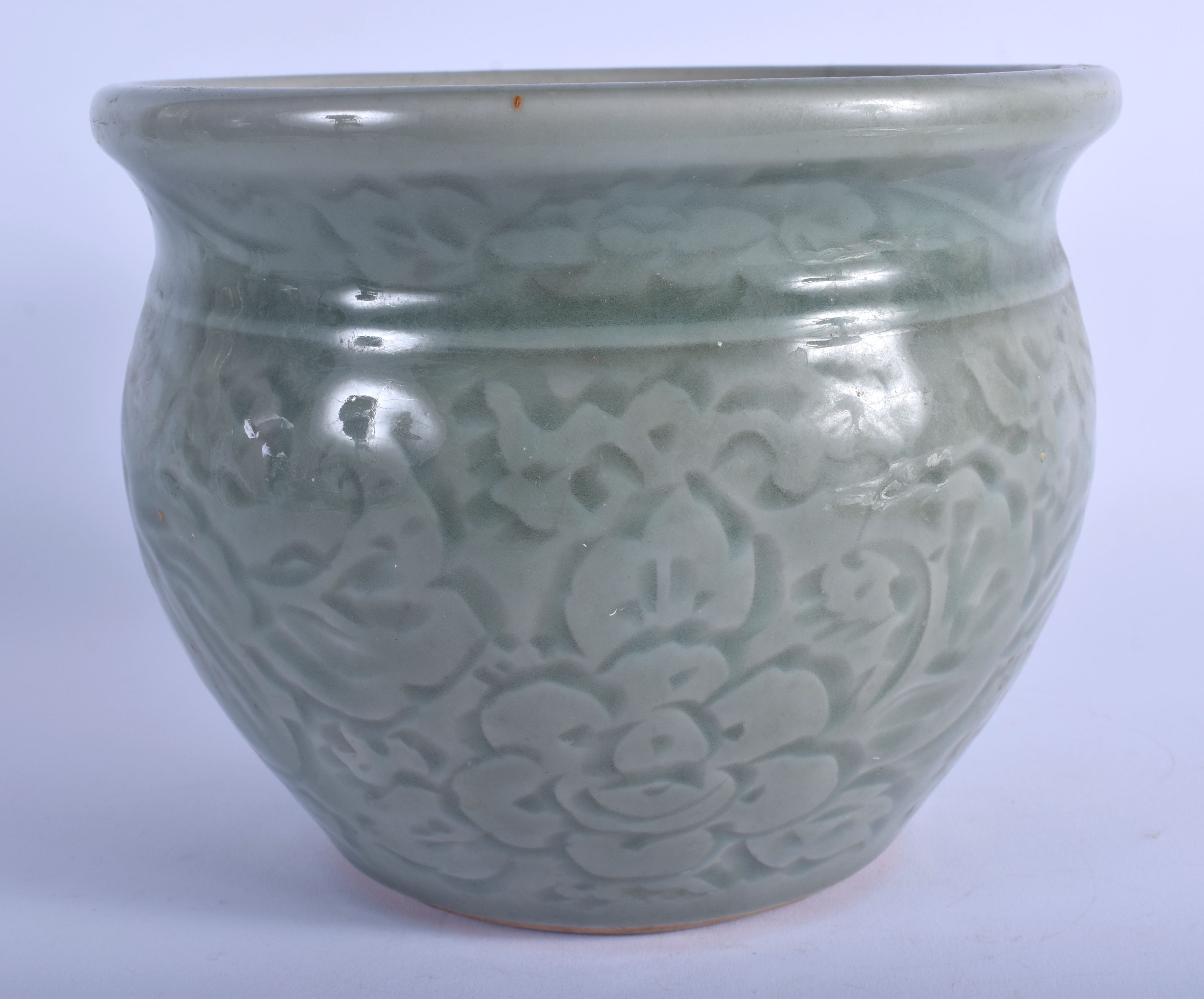 A 19TH CENTURY CHINESE CELADON POTTERY JARDINIERE decorated with foliage and vines. 13 cm x 16 cm.