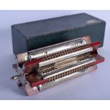 A BOXED VINTAGE HOHNER SEXTET PADDLE WHEEL TREMOLO HARMONICA. 22.5 cm wide.