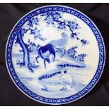 A large Blue and white oriental charger decorated with horses 47cm